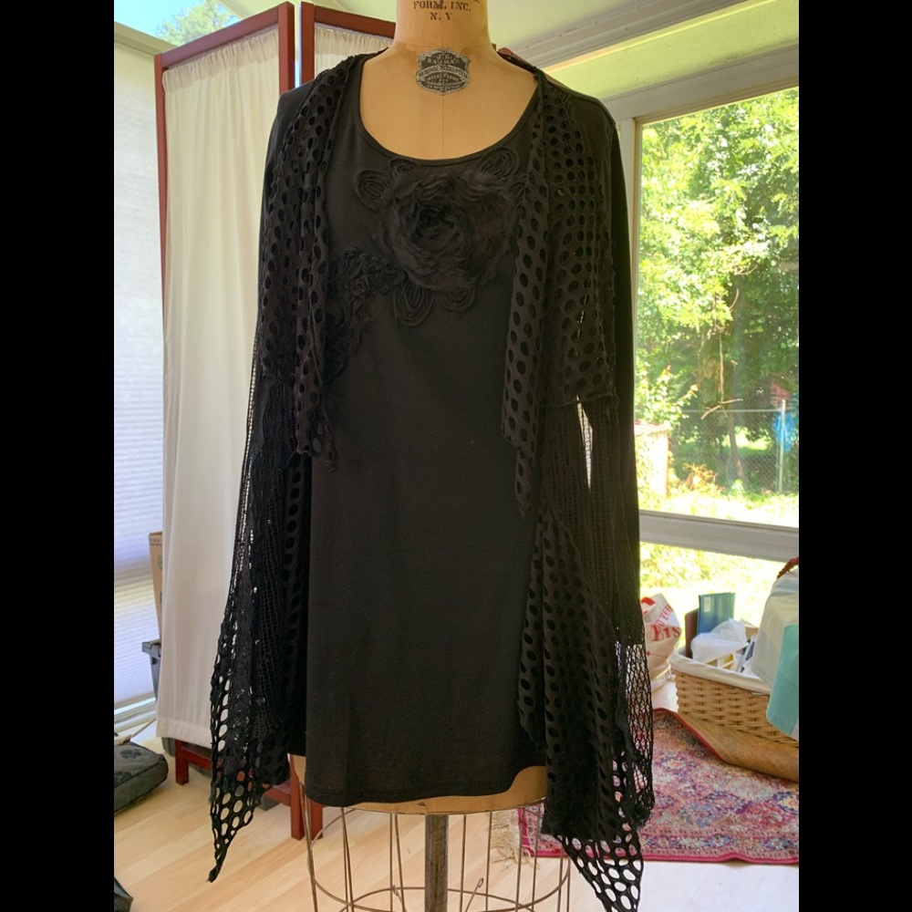 Flirty BLACK top with interesting details.